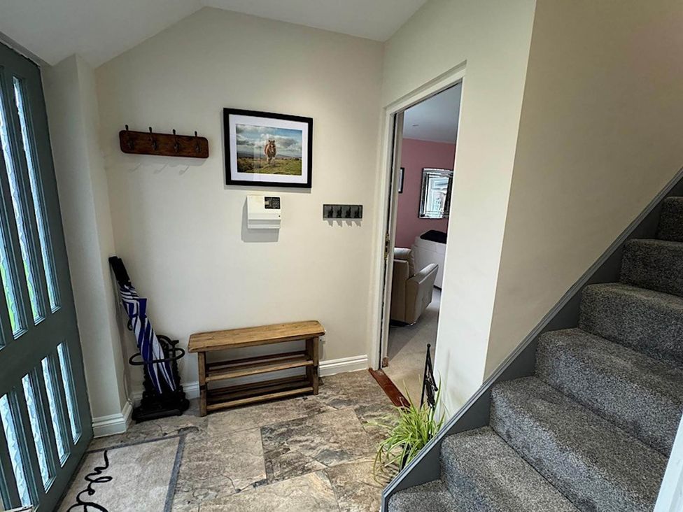 A hallway with a coat rack and bench at River Tamar Couples Retreat Dog Friendly Newbridge