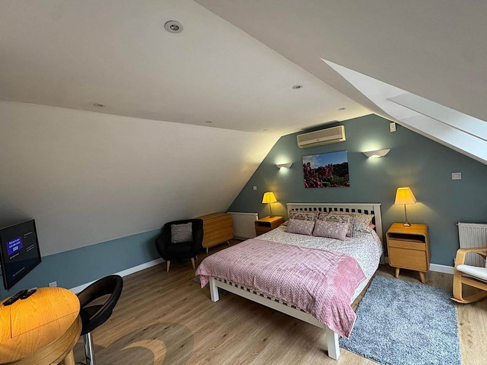 A bedroom with a bed and nightstand at River Tamar Couples Retreat Dog Friendly in Newbridge
