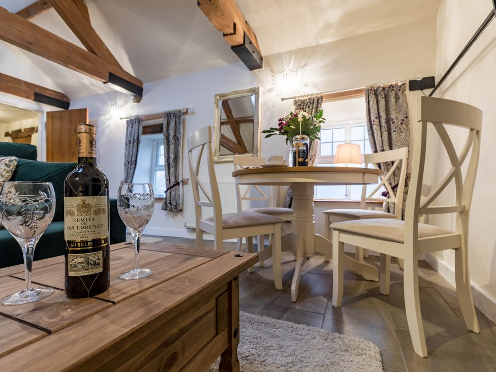 A dining room with a table and chairs at The Stables at Brambles Farm Sleeps 2 Wifi, Leek