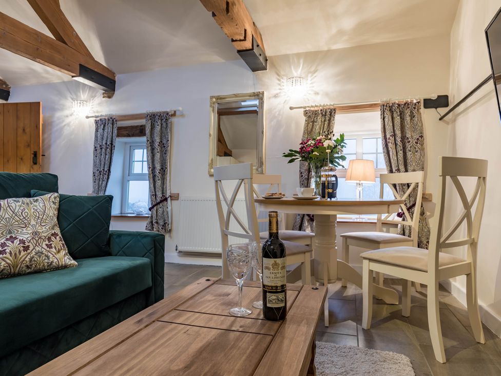 A dining room with a table and chairs at The Stables at Brambles Farm Sleeps 2 Wifi in Leek