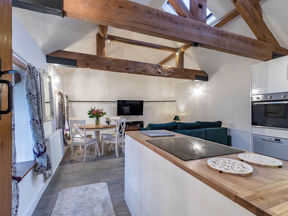 A kitchen with dining area and living space at The Stables at Brambles Farm Sleeps 2 Wifi in Leek