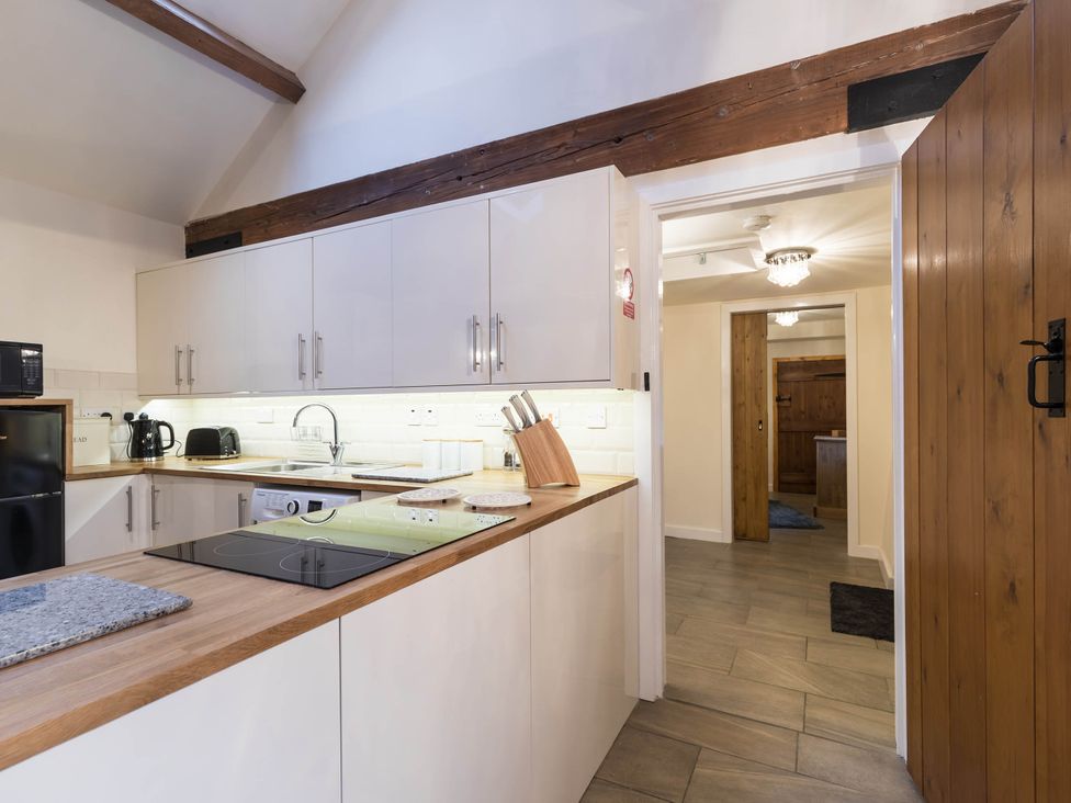 A kitchen with cabinets countertops and appliances at The Stables at Brambles Farm Sleeps 2 Wifi in Leek