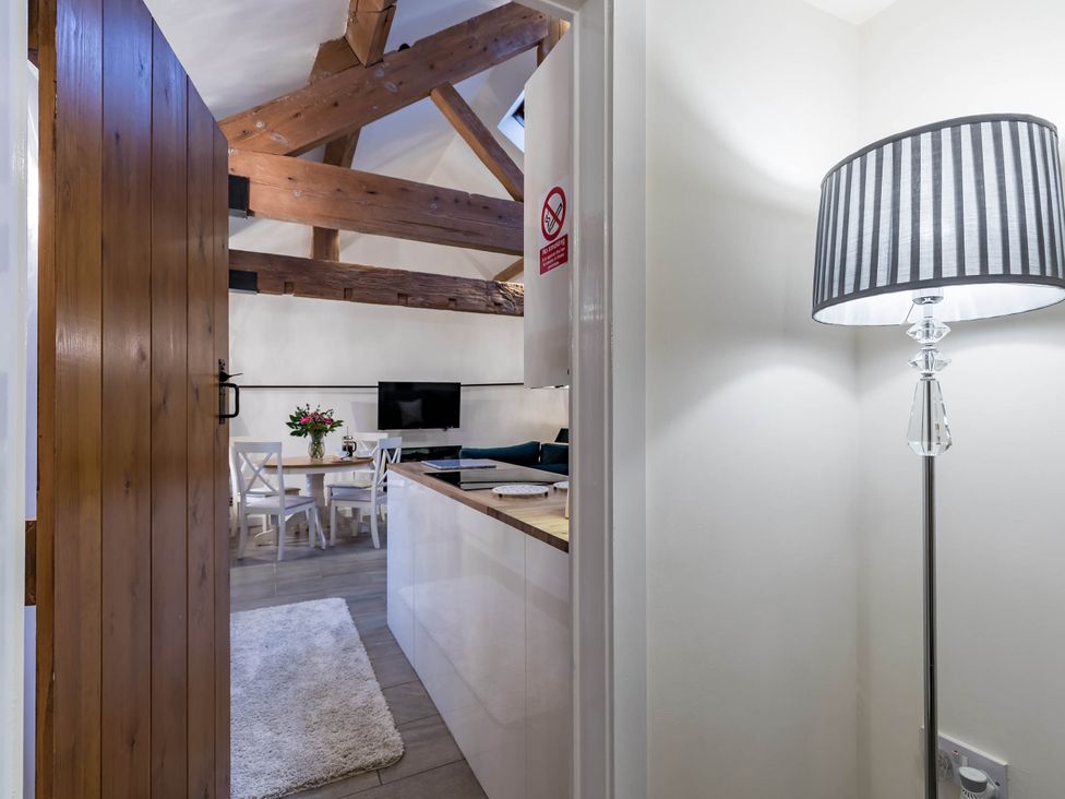 A living room with a table and chairs at The Stables at Brambles Farm Sleeps 2 Wifi Leek