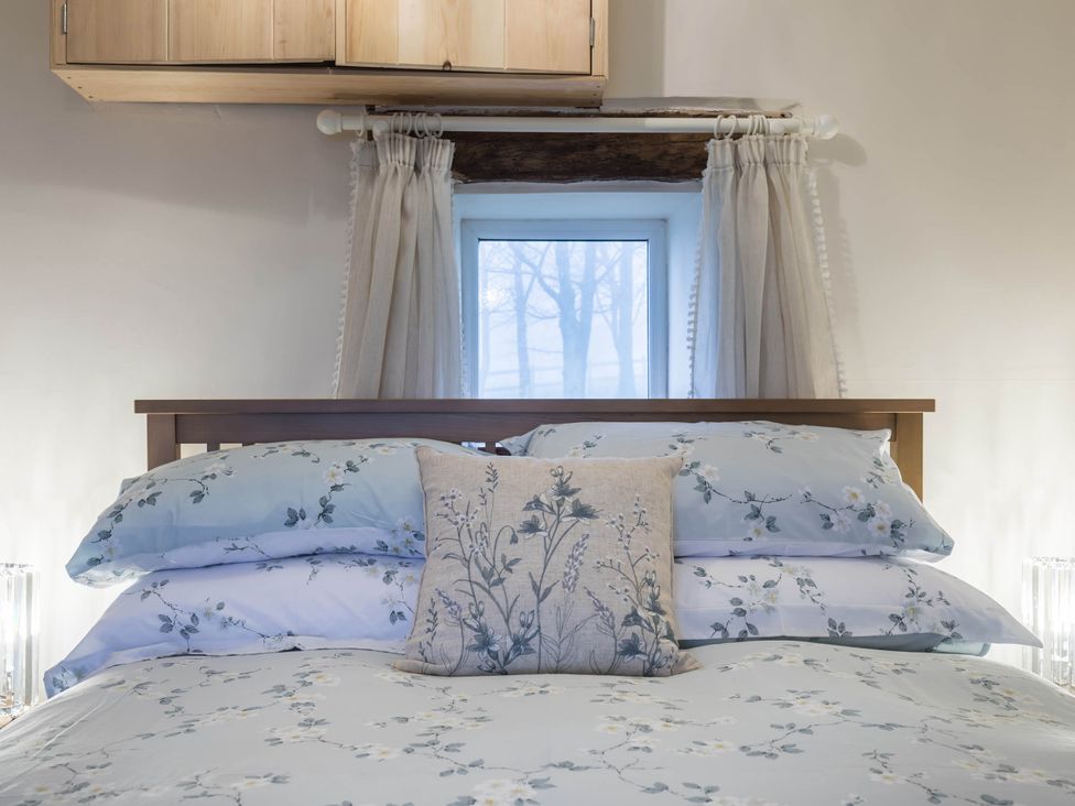 A bedroom with a bed and pillows at The Stables at Brambles Farm Sleeps 2 Wifi Leek