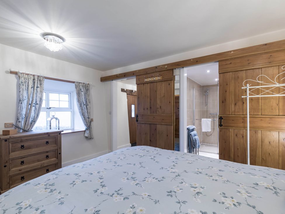 A bedroom with a bed and dresser at The Stables at Brambles Farm Sleeps 2 Wifi in Leek