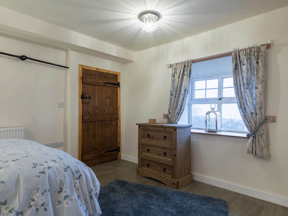 A bedroom with a bed and a dresser at The Stables at Brambles Farm Sleeps 2 Wifi Leek