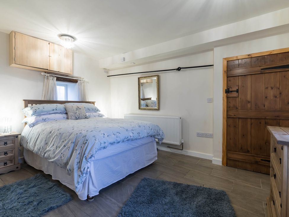 A bedroom with a bed and mirror at The Stables at Brambles Farm Sleeps 2 Wifi Leek