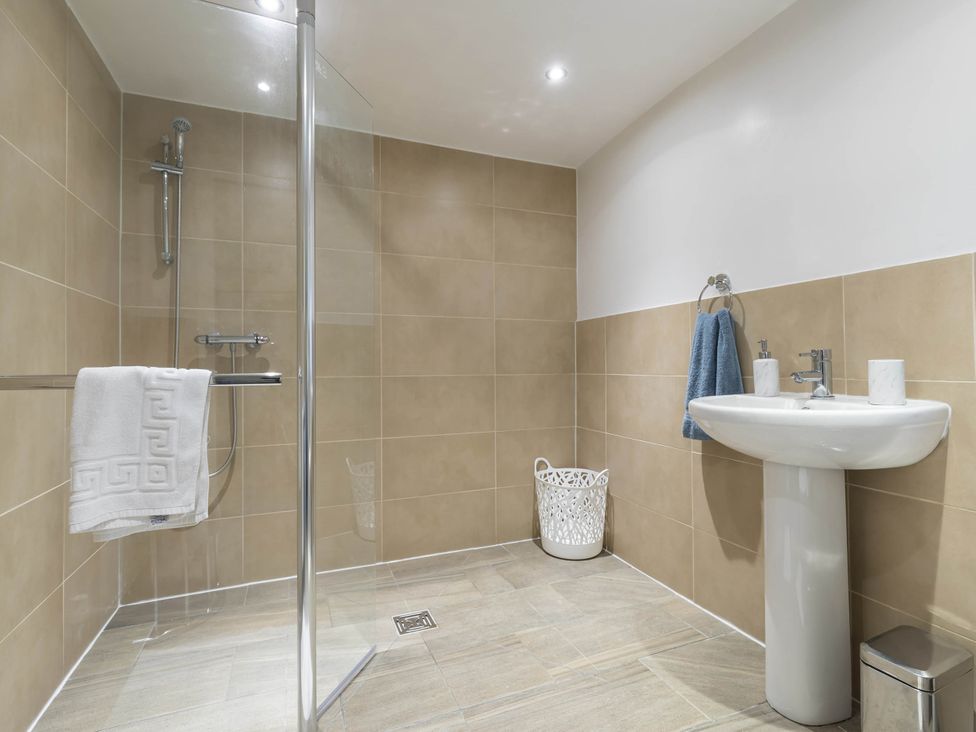 A bathroom with a shower and sink at The Stables at Brambles Farm Sleeps 2 Wifi Leek