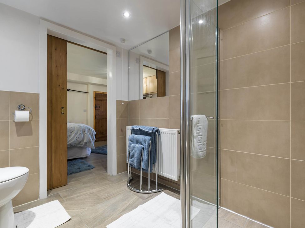 A bathroom with a toilet and shower at The Stables at Brambles Farm Sleeps 2 Wifi Leek