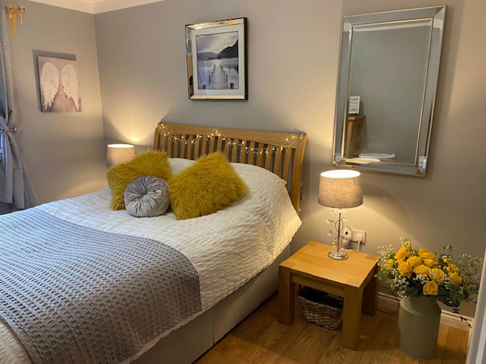 A bedroom with a bed and lamp at Blairgowrie Luxury 3 Bed Lodge with Hot Tub in Blairgowrie
