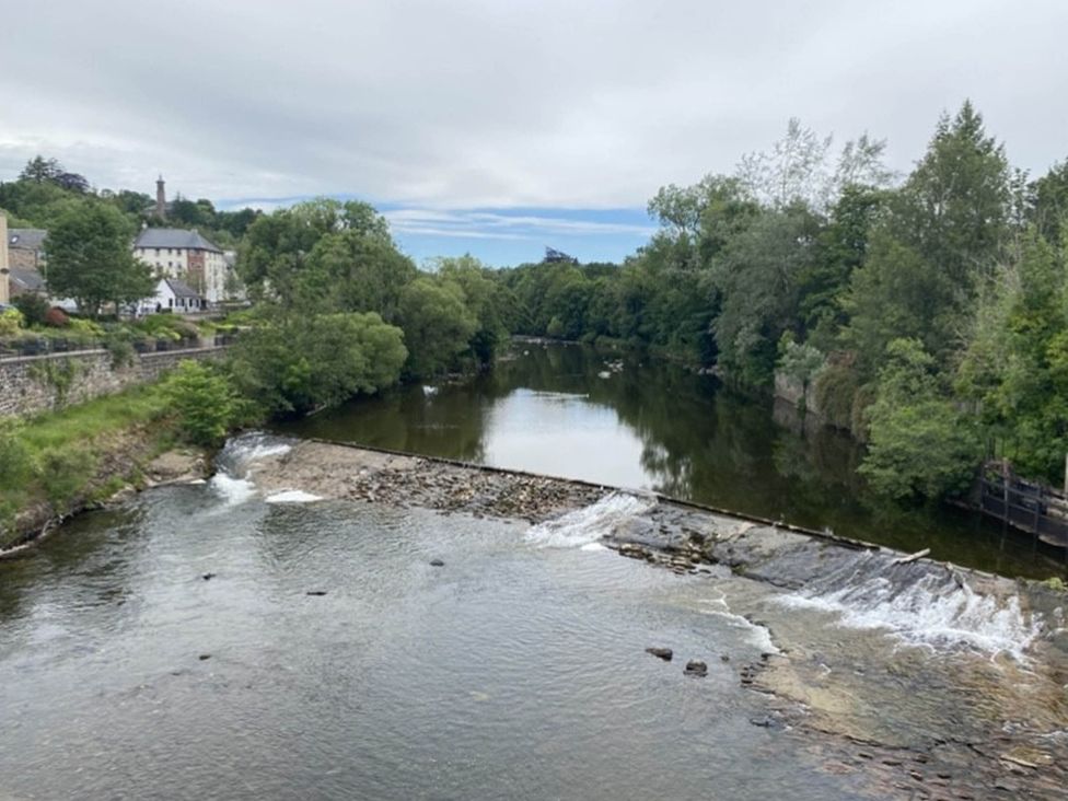 A river with a waterfall and trees at Blairgowrie Luxury 3 Bed Lodge with Hot Tub Blairgowrie