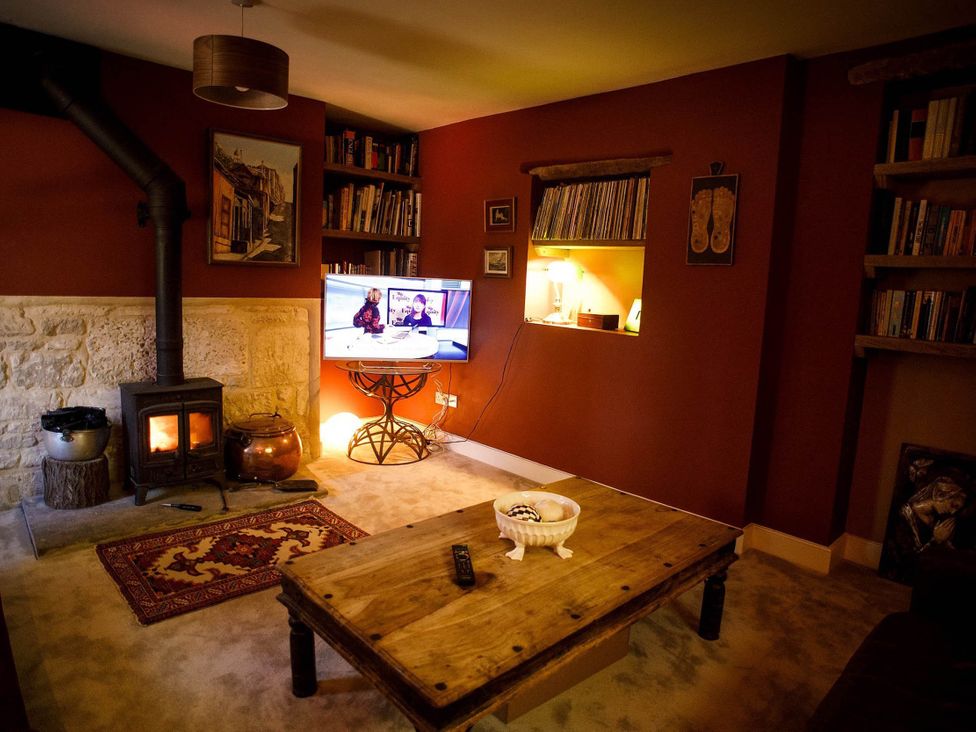 A living room with a wood stove and a television at Cotswolds AoNB Cottage Modern Renovation Sleeps8, Combe Hay Lane near Bath