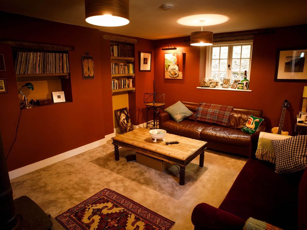 A living room with a sofa and bookshelf at Cotswolds AoNB Cottage Modern Renovation Sleeps8, Combe Hay Lane near Bath
