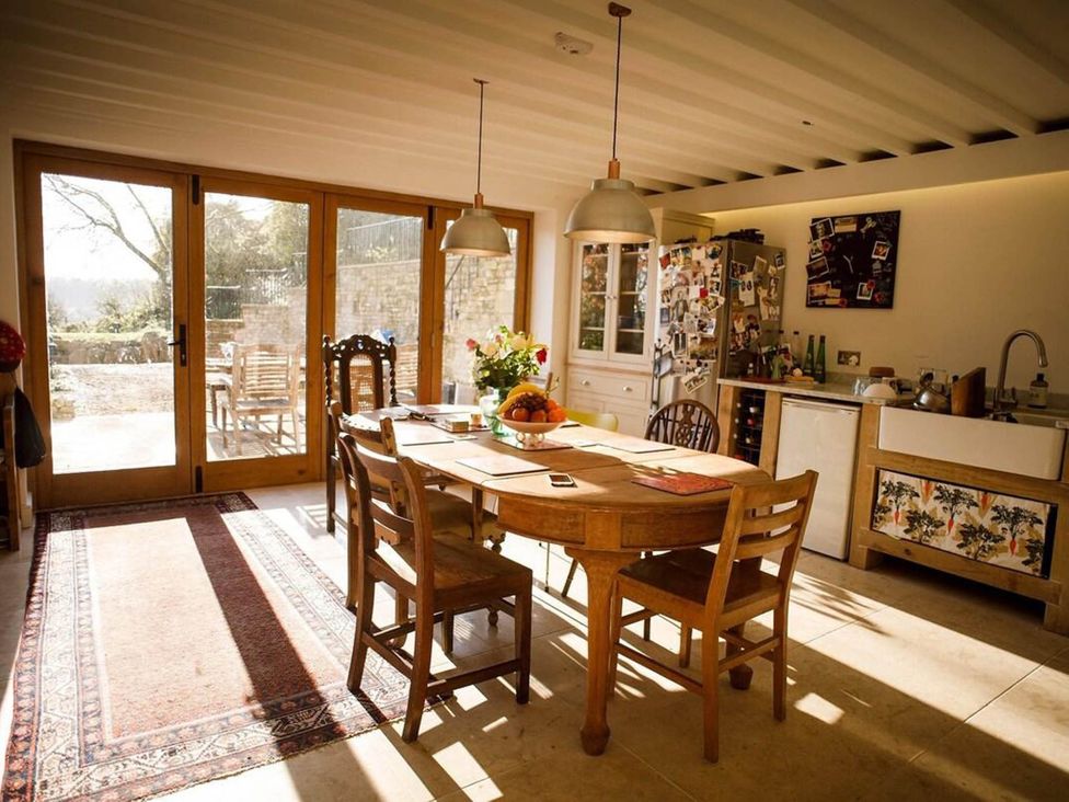 A kitchen with a dining table and chairs at Cotswolds AoNB Cottage Modern Renovation Sleeps8 Combe Hay Lane near Bath