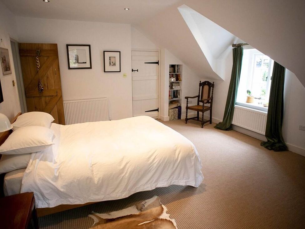 A bedroom with a bed and chair at Cotswolds AoNB Cottage Modern Renovation Sleeps8, Combe Hay Lane near Bath