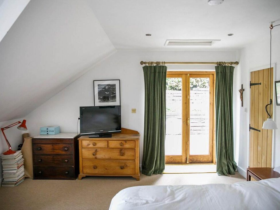 A bedroom with a television and dresser at Cotswolds AoNB Cottage Modern Renovation Sleeps8, Combe Hay Lane near Bath