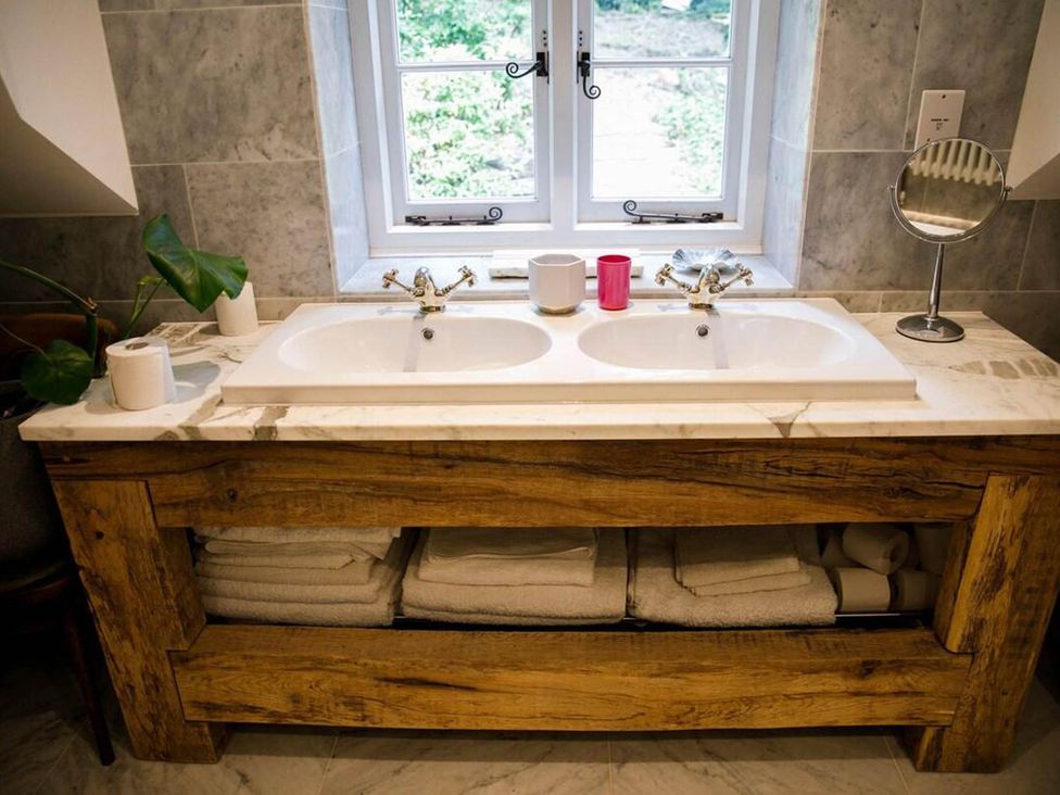 A bathroom with a double sink and wooden countertop at Cotswolds AoNB Cottage Modern Renovation Sleeps8 Combe Hay Lane near Bath