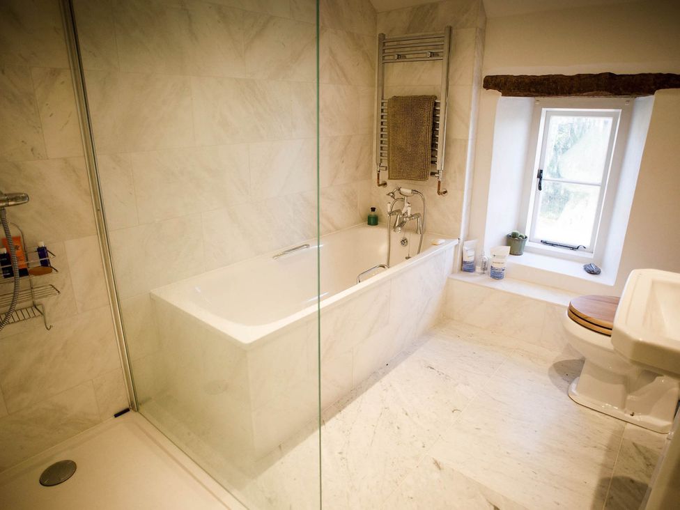 A bathroom with a bathtub and toilet at Cotswolds AoNB Cottage Modern Renovation Sleeps8 Combe Hay Lane near Bath
