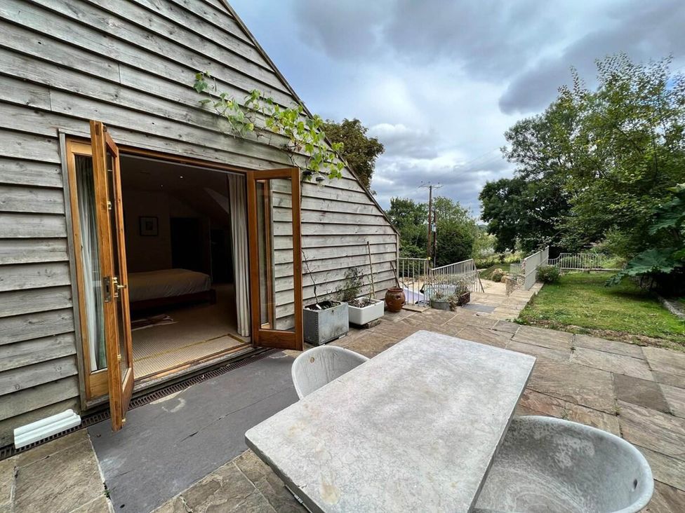 An outdoor area with a wooden building and furniture at Cotswolds AoNB Cottage Modern Renovation Sleeps8 Combe Hay Lane near Bath