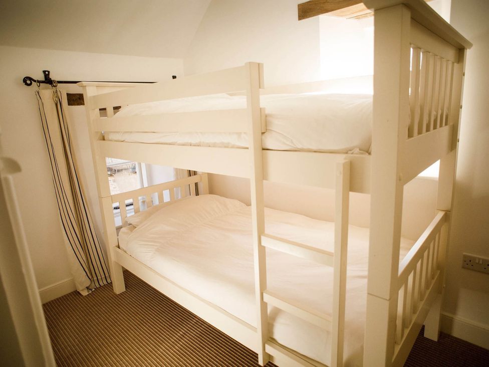 A bedroom with a bunk bed and window at Cotswolds AoNB Cottage Modern Renovation Sleeps8 Combe Hay Lane near Bath