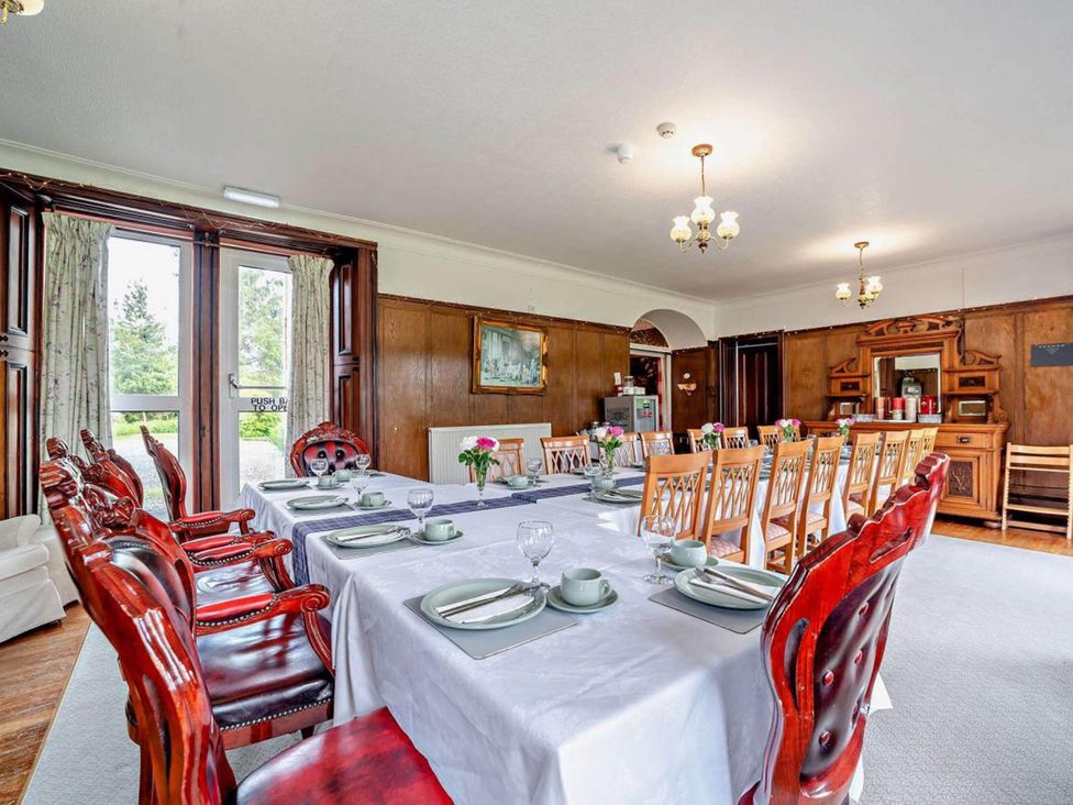 A dining room with table set for a meal at Dunoon Sleeps 17 Group Retreat with Parking in Kirn near Dunoon