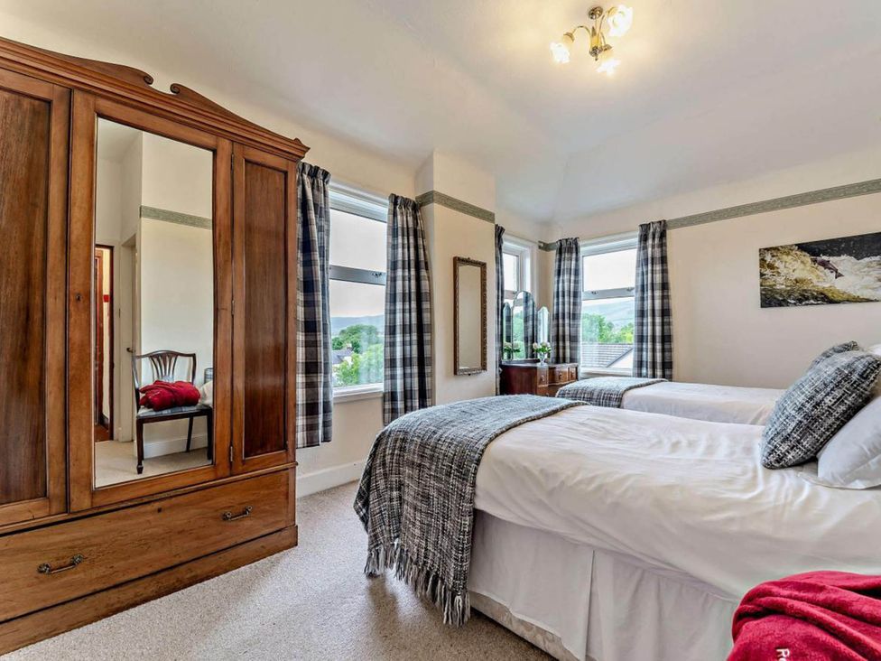 A bedroom with two beds and a wardrobe at Dunoon Sleeps 17 Group Retreat with Parking in Kirn near Dunoon