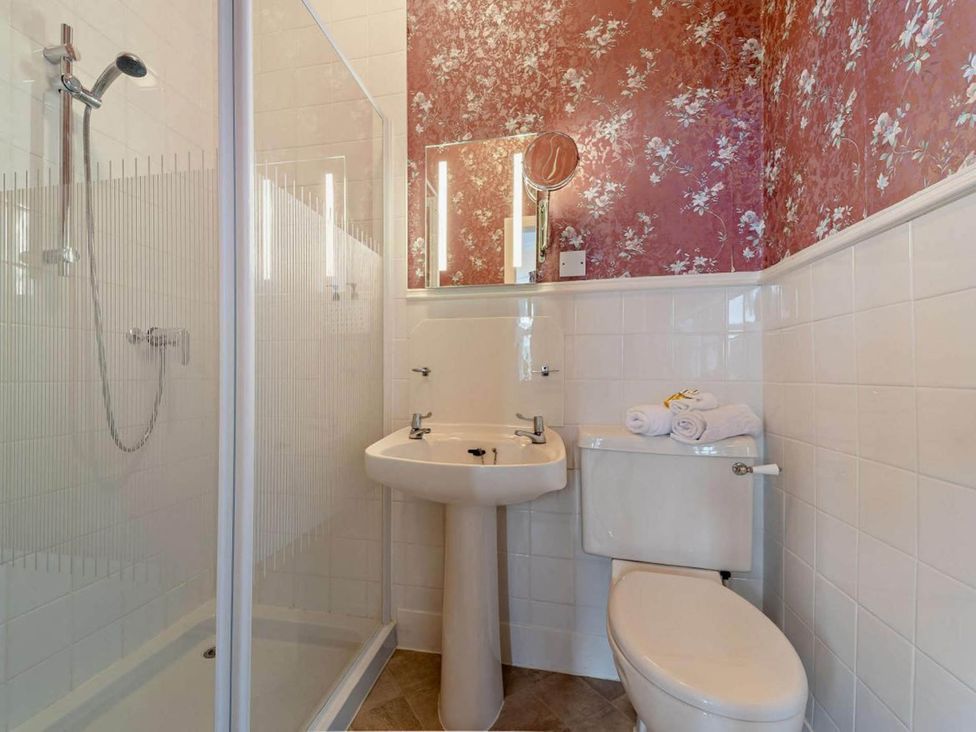 A bathroom with a shower, sink, and toilet at Dunoon Sleeps 17 Group Retreat with Parking Kirn near Dunoon