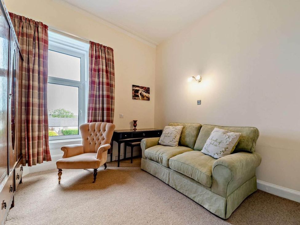 A living room with a sofa and armchair at Dunoon Sleeps 17 Group Retreat with Parking in Kirn near Dunoon