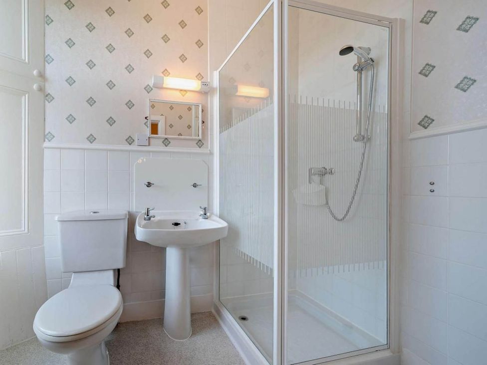 A bathroom with a shower, sink, and toilet at Dunoon Sleeps 17 Group Retreat with Parking in Kirn near Dunoon