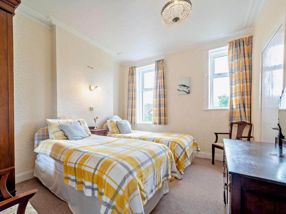 A bedroom with twin beds and a wooden chest of drawers at Dunoon Sleeps 17 Group Retreat with Parking in Kirn near Dunoon