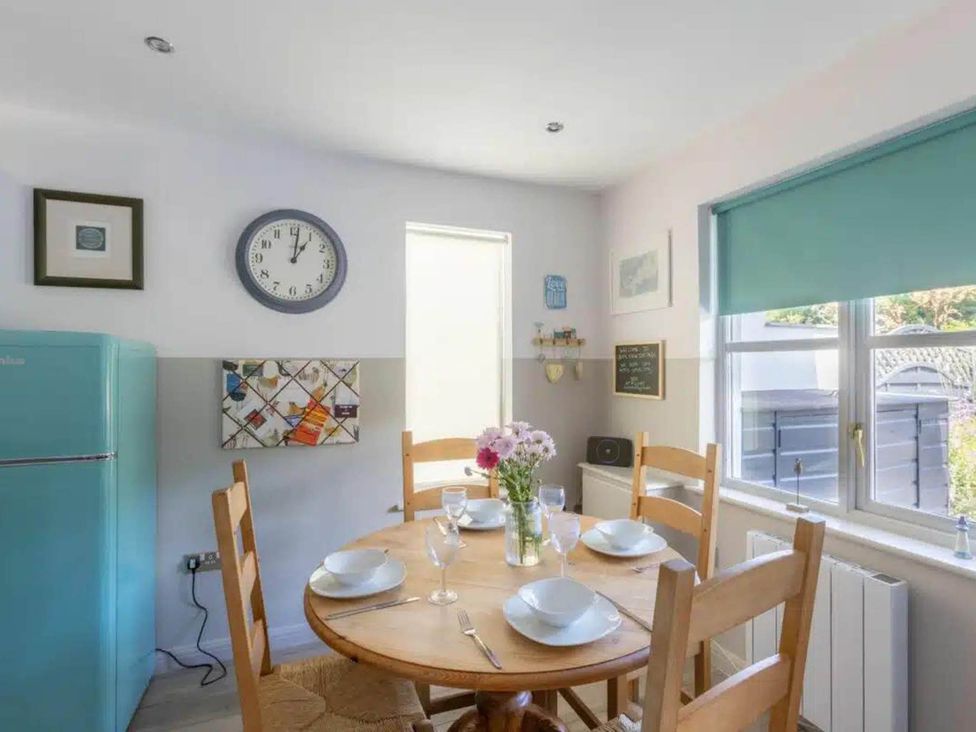 A dining room with a table and chairs at 2 Bedrooms overlooking Little Petherick Creek Little Petherick