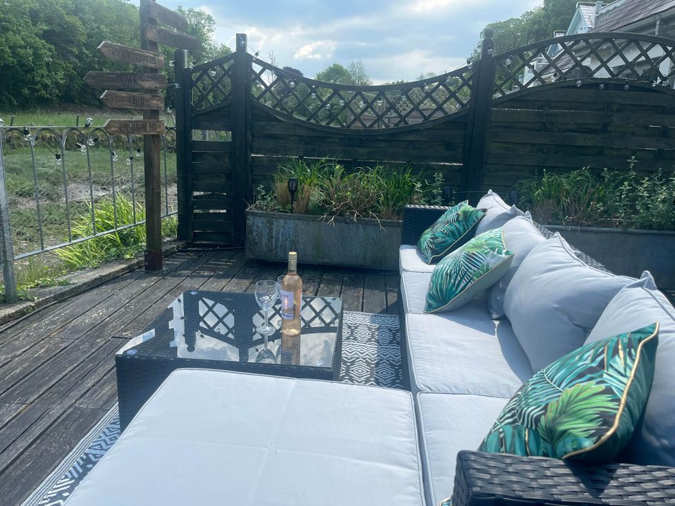An outdoor area with a couch and coffee table at 2 Bedrooms overlooking Little Petherick Creek in Little Petherick