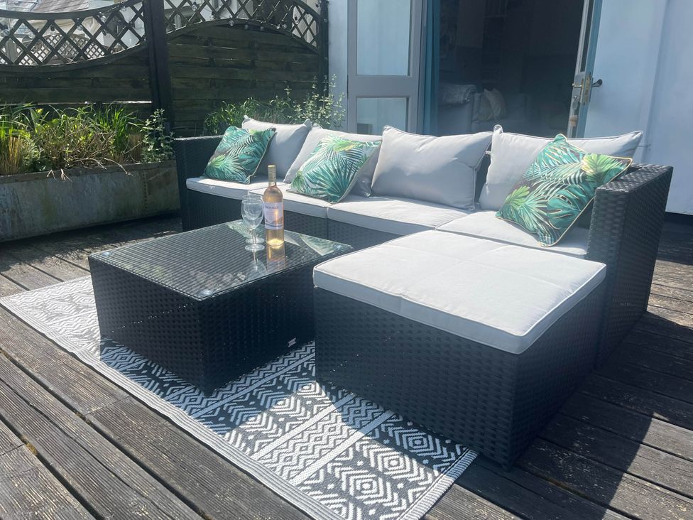 An outdoor seating area with a sofa and coffee table at 2 Bedrooms overlooking Little Petherick Creek Little Petherick
