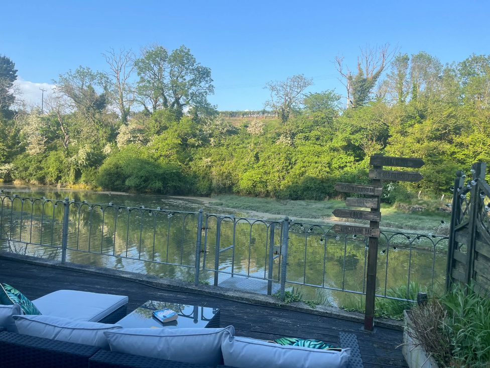 An outdoor area with a river and seating at 2 Bedrooms overlooking Little Petherick Creek in Little Petherick