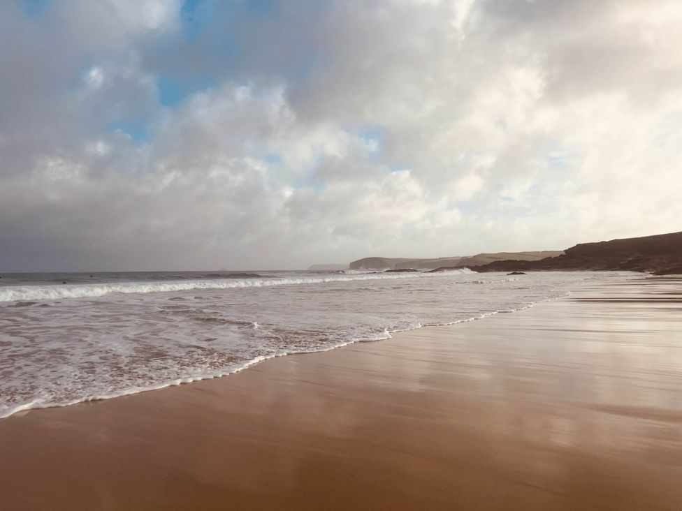 A beach with waves lapping the shore at 2 Bedrooms overlooking Little Petherick Creek Little Petherick