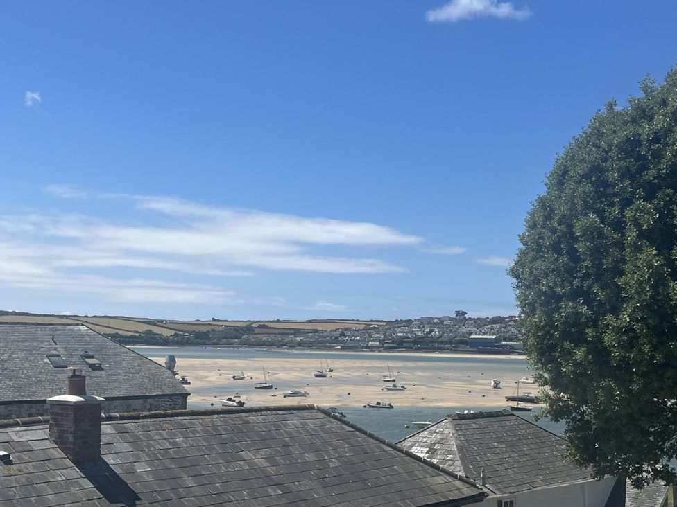 A view of boats in water with rooftops and a tree at 2 Bedrooms overlooking Little Petherick Creek Little Petherick
