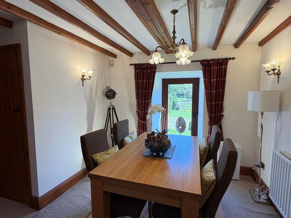 A dining room with a table and chairs at The Old Barn in Whiston near Cheadle