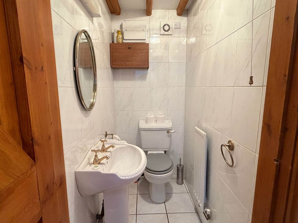 A bathroom with a sink and toilet at The Old Barn in Whiston near Cheadle