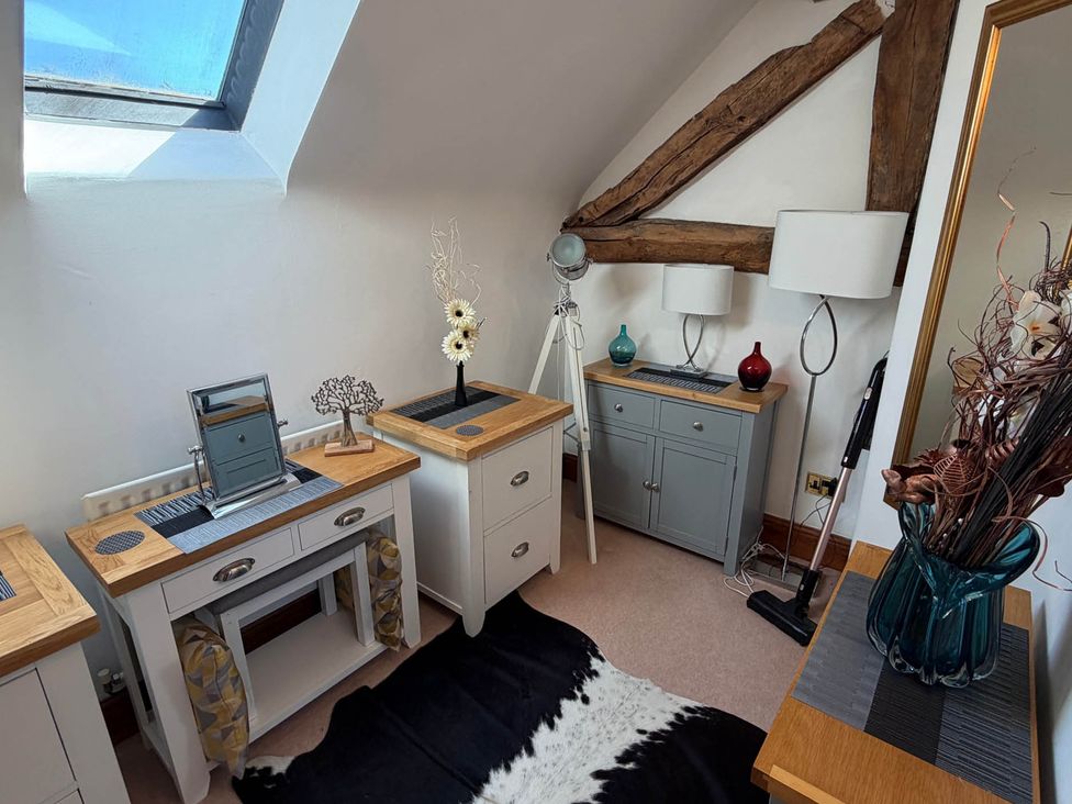 A bedroom with furniture and decor at The Old Barn in Whiston near Cheadle
