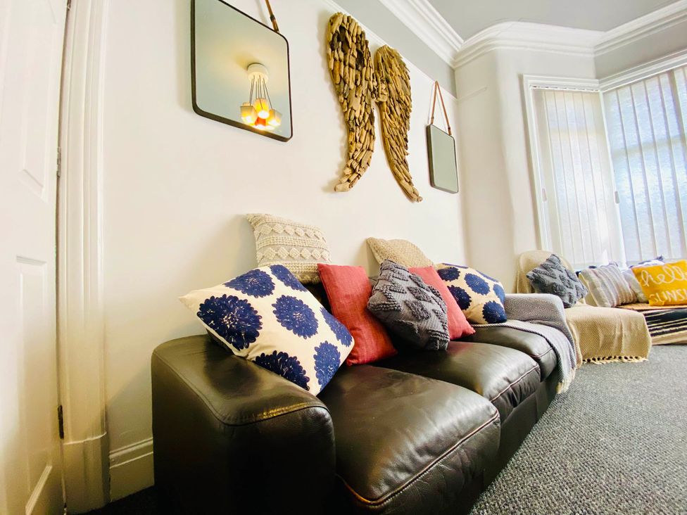 A living room with a sofa and decorative pillows at Blackpool 4 Beds Sleeps 10 Pet Friendly, Blackpool
