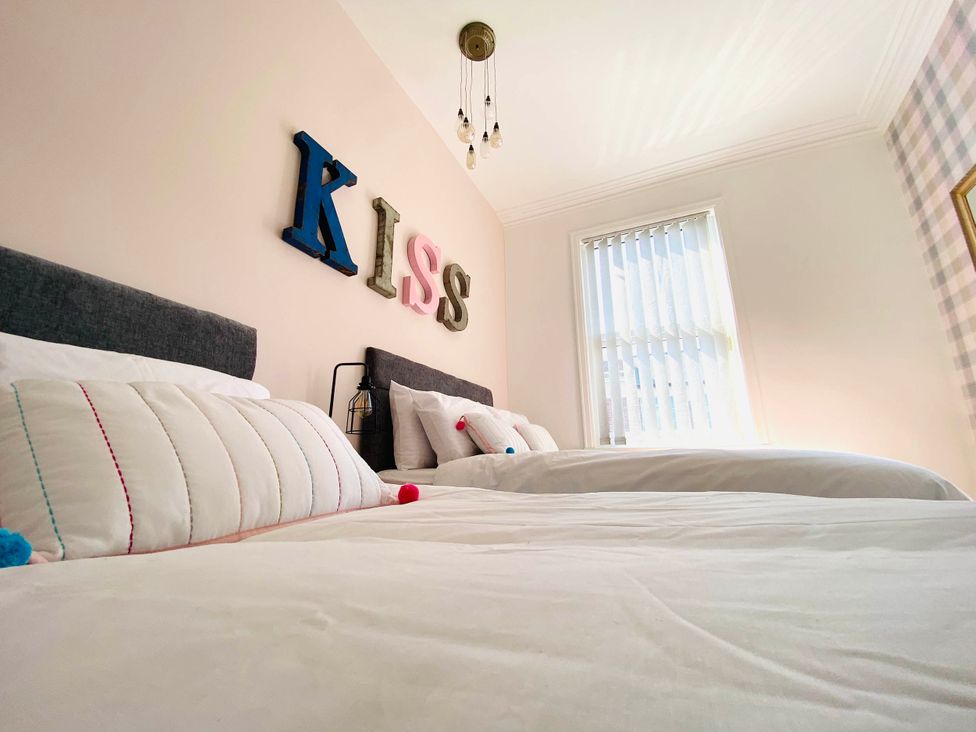 A bedroom with two beds and a window at Blackpool 4 Beds Sleeps 10 Pet Friendly in Blackpool