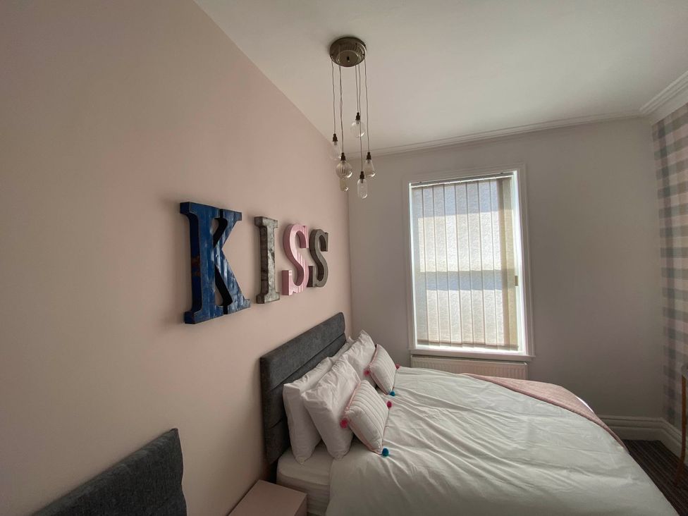 A bedroom with a bed and decorative letters at Blackpool 4 Beds Sleeps 10 Pet Friendly in Blackpool