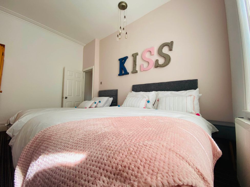 A bedroom with two beds, pillows, and wall decor at Blackpool 4 Beds Sleeps 10 Pet Friendly, Blackpool
