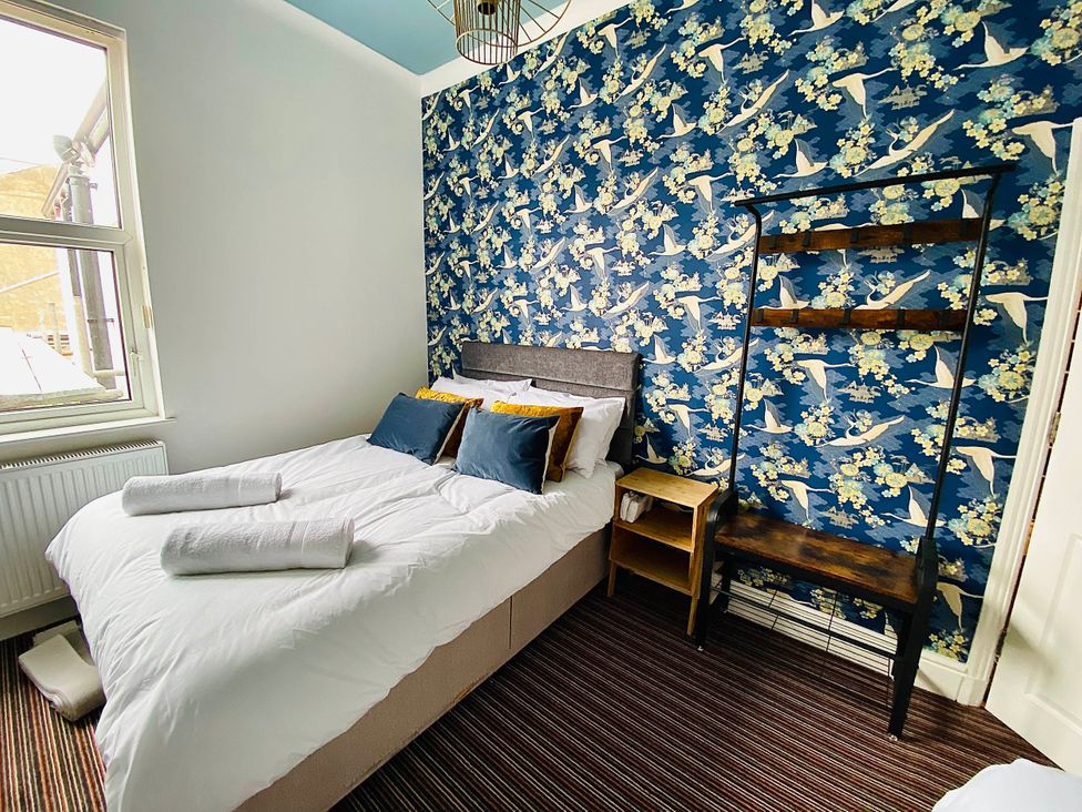 A bedroom with a bed and a shelf at Blackpool 4 Beds Sleeps 10 Pet Friendly Blackpool