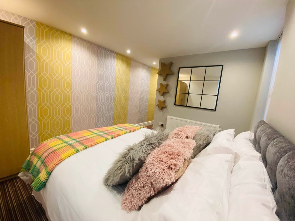 A bedroom with a bed and decorative items at Blackpool 4 Beds Sleeps 10 Pet Friendly in Blackpool