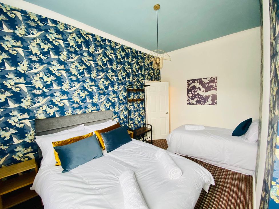 A bedroom with a double bed and twin bed at Blackpool 4 Beds Sleeps 10 Pet Friendly, Blackpool