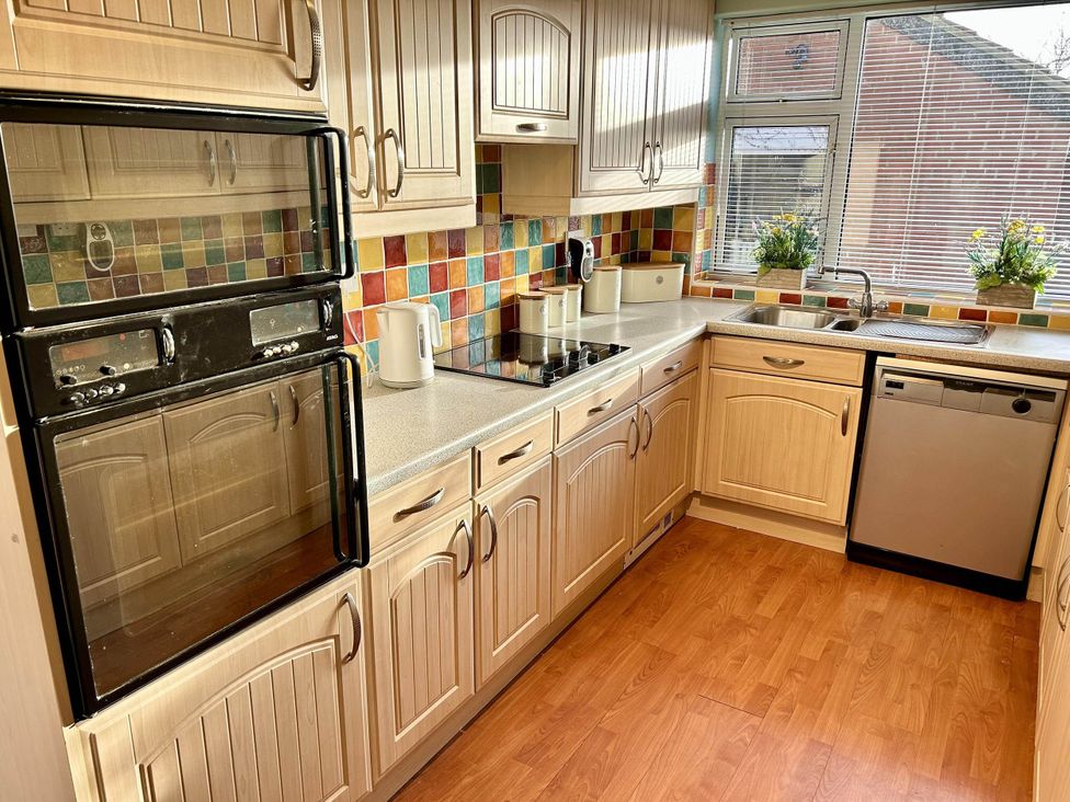 A kitchen with cabinets, oven, sink, and dishwasher at 6 Guests 3Bed House in Chester-Le-Street