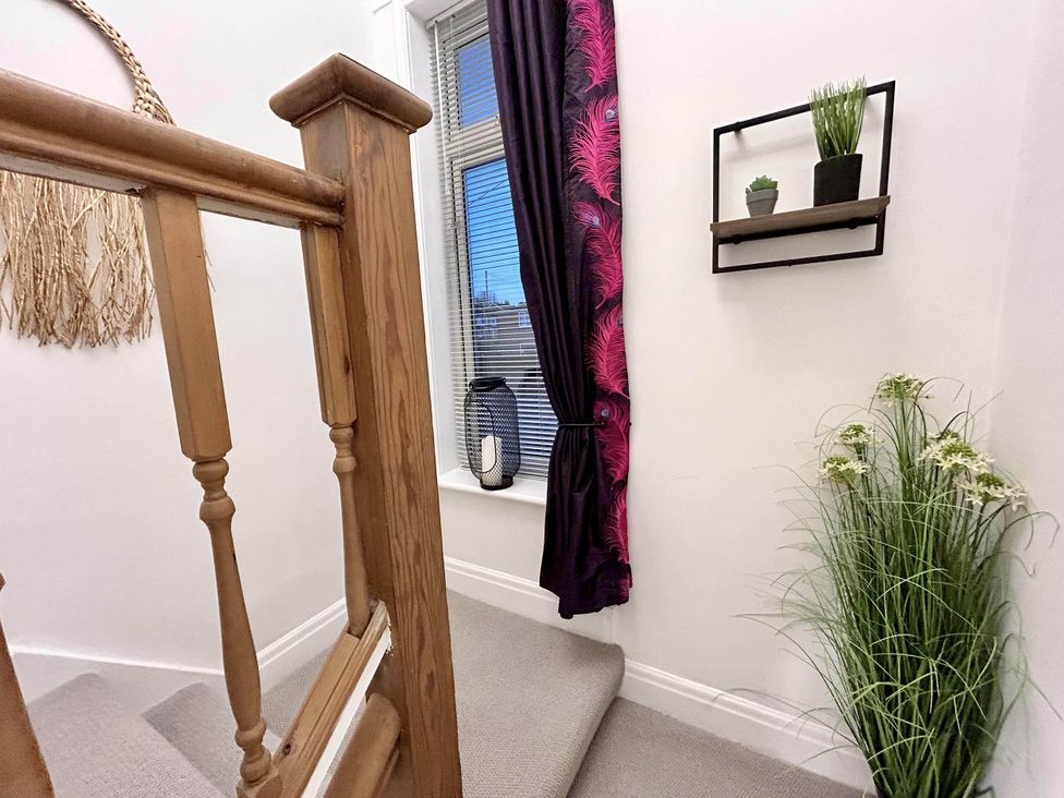 A staircase with a window and decorative plants at 6 Guests 3Bed House in Chester-Le-Street