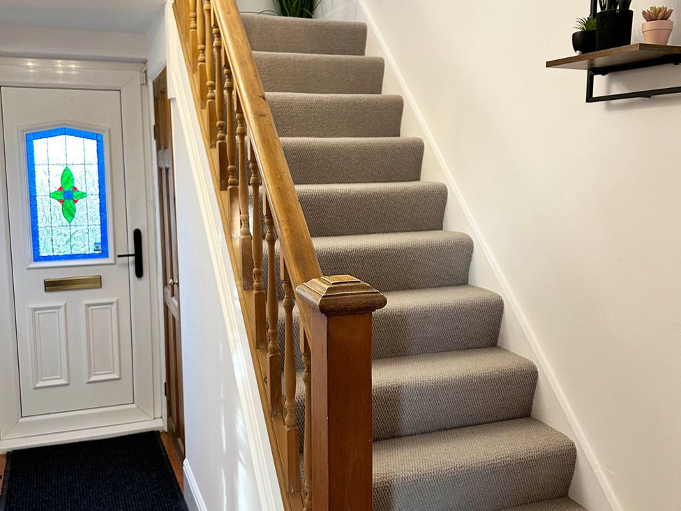A staircase leading up with a door at the entrance at 6 Guests 3Bed House in Chester-Le-Street