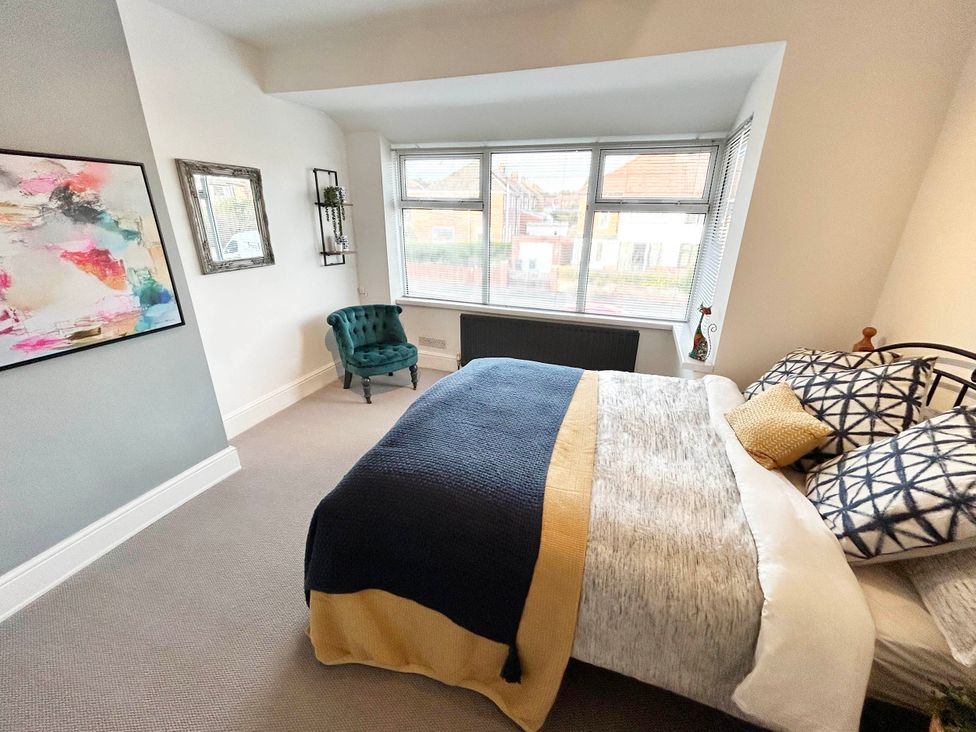 A bedroom with a bed and a chair at 6 Guests 3Bed House in Chester le Street